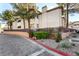 Building exterior showcasing landscaping and a paved driveway at 108 Breezy Tree Ct # 202, Las Vegas, NV 89145