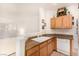 Kitchen with wood cabinets, granite counters, and white appliances at 108 Breezy Tree Ct # 202, Las Vegas, NV 89145