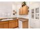 Kitchen boasts wood cabinets, granite countertops, and a white dishwasher at 108 Breezy Tree Ct # 202, Las Vegas, NV 89145