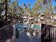 Community pool area with plenty of lounge chairs for sunbathing at 108 Breezy Tree Ct # 202, Las Vegas, NV 89145