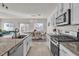 Modern kitchen with white cabinets, granite countertops and stainless steel appliances at 10931 Cambridge Lakes Ave, Las Vegas, NV 89166