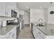 Bright kitchen with white cabinets, granite countertops, and stainless steel appliances at 10931 Cambridge Lakes Ave, Las Vegas, NV 89166