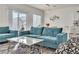 Comfortable living room featuring a teal sofa and marble coffee table at 10931 Cambridge Lakes Ave, Las Vegas, NV 89166