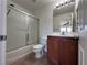 Bathroom with tub, shower, and wood vanity at 1096 Country Coach Dr, Henderson, NV 89002