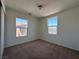 Bright bedroom with carpet flooring and two large windows at 1096 Country Coach Dr, Henderson, NV 89002