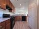 Modern kitchen with wood cabinets and black appliances at 1096 Country Coach Dr, Henderson, NV 89002