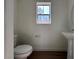 Small powder room with pedestal sink and toilet at 1096 Country Coach Dr, Henderson, NV 89002