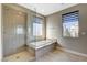 Bathroom with soaking tub, walk-in shower, and window at 11275 Idyllic Dr # 101, Las Vegas, NV 89135