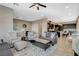 Open concept living room with gray sofas, a coffee table, and views into kitchen at 11275 Idyllic Dr # 101, Las Vegas, NV 89135