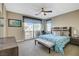 Main bedroom with large bed, balcony access, and ensuite bathroom at 11275 Idyllic Dr # 101, Las Vegas, NV 89135