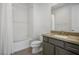 Modern bathroom with gray vanity, white tub, and tiled floor at 11809 Stone Run Ave, Las Vegas, NV 89138