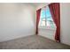 Bright bedroom with large window and red curtains at 11809 Stone Run Ave, Las Vegas, NV 89138