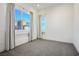 Bedroom with large windows and gray carpet at 11809 Stone Run Ave, Las Vegas, NV 89138