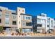 Contemporary townhomes featuring unique architectural details and desert landscaping under a clear blue sky at 11809 Stone Run Ave, Las Vegas, NV 89138