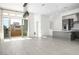 Bright, open living space connects the kitchen and balcony through large glass doors, with neutral tile floors at 11809 Stone Run Ave, Las Vegas, NV 89138