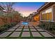 Landscaped backyard with a pool and modern patio design at 12031 Attiva Ave, Las Vegas, NV 89138