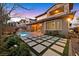 Landscaped backyard with a pool and modern patio design at 12031 Attiva Ave, Las Vegas, NV 89138