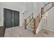 Modern entryway with dark gray double doors and a wooden staircase at 12031 Attiva Ave, Las Vegas, NV 89138