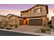 Two-story house with brown exterior, landscaped yard, and a three-car garage at 12031 Attiva Ave, Las Vegas, NV 89138