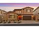 Two-story house with brown exterior, landscaped yard, and a three-car garage at 12031 Attiva Ave, Las Vegas, NV 89138