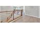 Upper hallway with modern wood railing overlooking lower level at 12031 Attiva Ave, Las Vegas, NV 89138