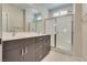 Modern bathroom with double vanity, large mirror, and walk-in shower at 1254 Venue St # 102, Las Vegas, NV 89135