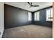 Spacious bedroom with carpeted floor, ceiling fan, and large windows at 1254 Venue St # 102, Las Vegas, NV 89135