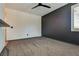 Well-lit bedroom with dark accent wall and ceiling fan at 1254 Venue St # 102, Las Vegas, NV 89135