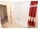 Clean bathroom with tub shower and red striped curtain at 1526 Carriagedale Ct, Las Vegas, NV 89110