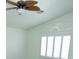 Bedroom with vaulted ceiling, fan, and window shutters at 1526 Carriagedale Ct, Las Vegas, NV 89110