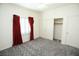 Bedroom with red curtains, double door closet, and grey carpet at 1526 Carriagedale Ct, Las Vegas, NV 89110