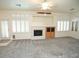 Bright living room featuring a fireplace and built-in shelving at 1526 Carriagedale Ct, Las Vegas, NV 89110