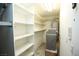 Storage room with white shelves and water softener at 1526 Carriagedale Ct, Las Vegas, NV 89110