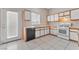 Galley-style kitchen with white cabinets and a back door at 1619 Wendell Williams Ave, Las Vegas, NV 89106