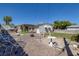 Backyard with covered patio, fire pit, and ample space for seating at 1704 Hassett Ave, Las Vegas, NV 89104