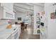 White kitchen with ample counter space and dining area view at 1704 Hassett Ave, Las Vegas, NV 89104