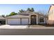 Single-story house with a three-car garage and desert landscaping at 1781 Lakewood Dr, Henderson, NV 89012