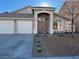 Two-story house with attached two-car garage, desert landscaping, and a welcoming entryway at 1781 Lakewood Dr, Henderson, NV 89012