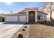 House exterior with a three-car garage and drought-tolerant landscaping at 1781 Lakewood Dr, Henderson, NV 89012