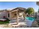 Relaxing backyard with a large pool, pergola, and built-in BBQ at 1781 Lakewood Dr, Henderson, NV 89012