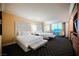 Spacious bedroom with two double beds, city view, and modern decor at 2000 Fashion Show Dr # 5400, Las Vegas, NV 89109