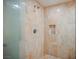 Large walk-in shower with marble tile and built-in shelf at 2000 Fashion Show Dr # 5400, Las Vegas, NV 89109