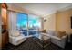 Comfortable living room with a sofa, armchair, and city views at 2000 Fashion Show Dr # 5428, Las Vegas, NV 89109