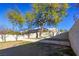 Landscaped backyard with mature trees and a large grassy area at 2044 Glorieta Ln, Las Vegas, NV 89134