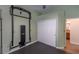 Functional home gym with wall-mounted rig and storage at 2044 Glorieta Ln, Las Vegas, NV 89134