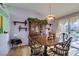 Bright dining room with hardwood floors and a charming wooden table at 2091 Poppywood Ave, Henderson, NV 89012