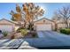 Single-story house with a two-car garage and desert landscaping at 2091 Poppywood Ave, Henderson, NV 89012