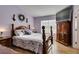 Main bedroom with large TV and wood furniture at 2091 Poppywood Ave, Henderson, NV 89012