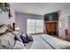 Main bedroom with large TV and wood furniture at 2091 Poppywood Ave, Henderson, NV 89012