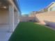 Spacious backyard with artificial turf and covered patio at 2110 Millergrove Ave, North Las Vegas, NV 89086